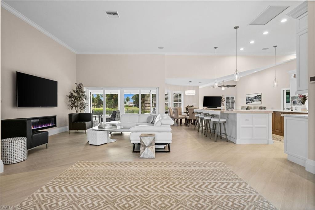 2022 Duke Drive Naples, FL 34110 - Photo 13 of 40 a living room with lots of furniture and a flat screen tv