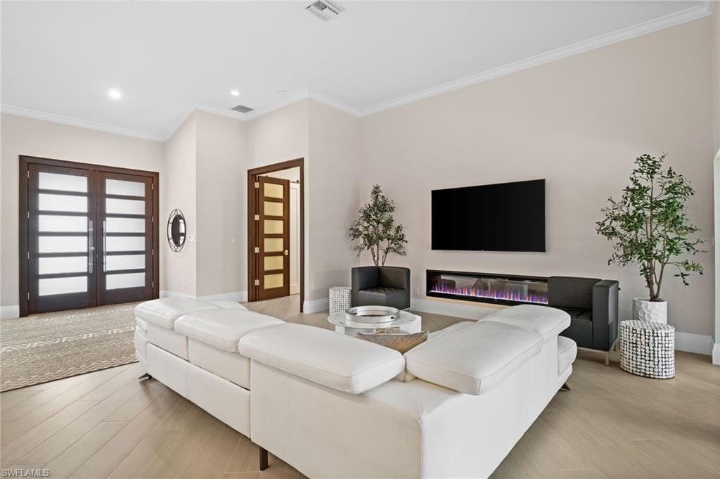 2022 Duke Drive Naples, FL 34110 - Photo 15 of 40 a bedroom with a large bed and a flat screen tv