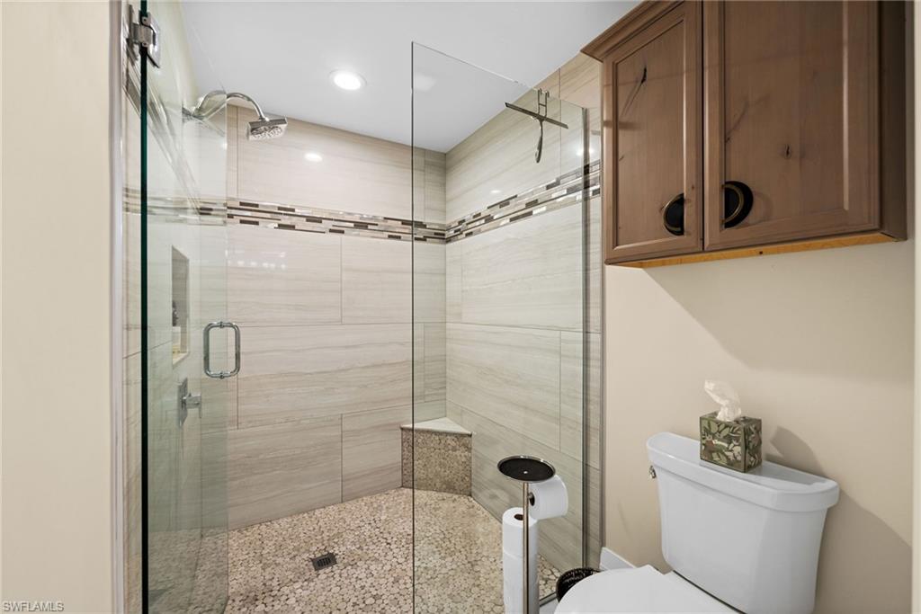 2022 Duke Drive Naples, FL 34110 - Photo 19 of 40 a bathroom with a shower a toilet and a sink