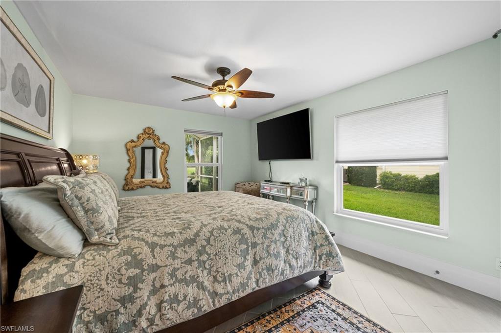 2022 Duke Drive Naples, FL 34110 - Photo 20 of 40 a bedroom with a bed and a flat screen tv