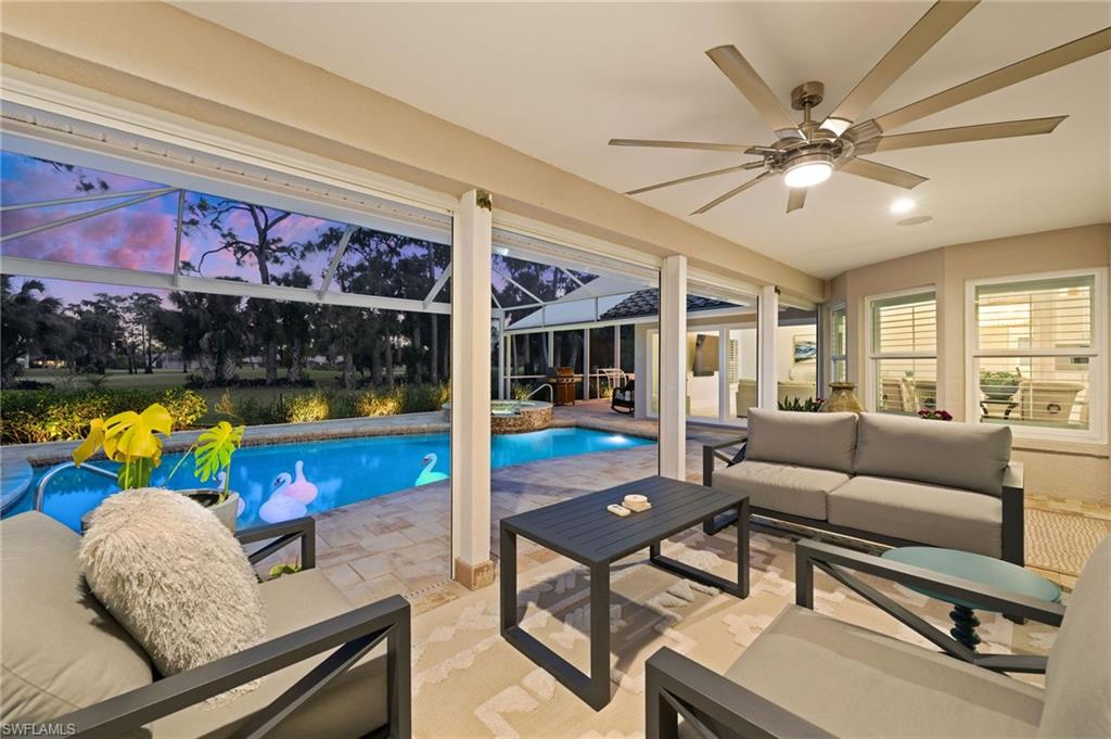 2022 Duke Drive Naples, FL 34110 - Photo 2 of 40 a living room with furniture and a flat screen tv