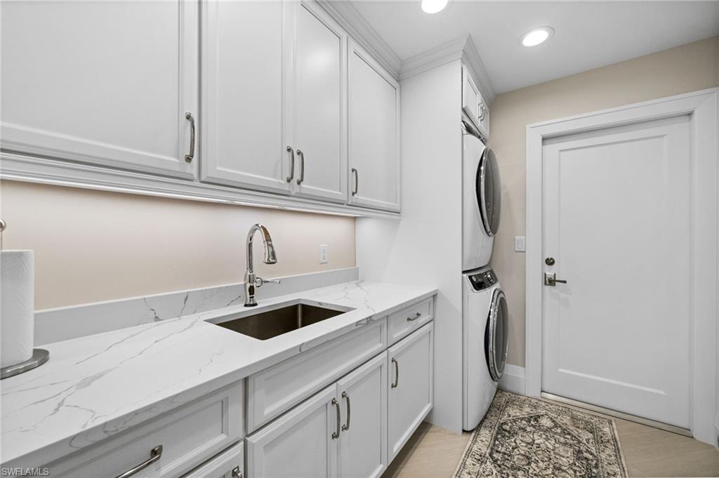 2022 Duke Drive Naples, FL 34110 - Photo 25 of 40 a kitchen with stainless steel appliances granite countertop a sink and a refrigerator