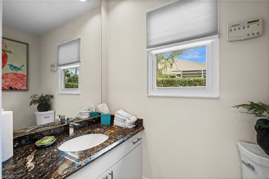 2022 Duke Drive Naples, FL 34110 - Photo 26 of 40 a bathroom with a granite countertop sink and a mirror