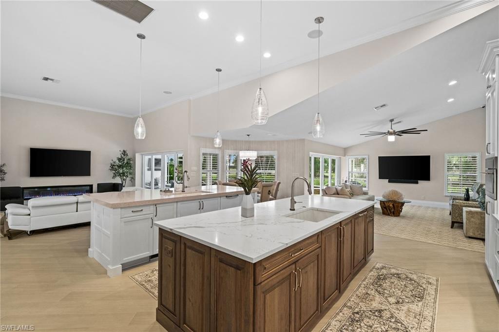 2022 Duke Drive Naples, FL 34110 - Photo 8 of 40 a large white kitchen with a large island in the center