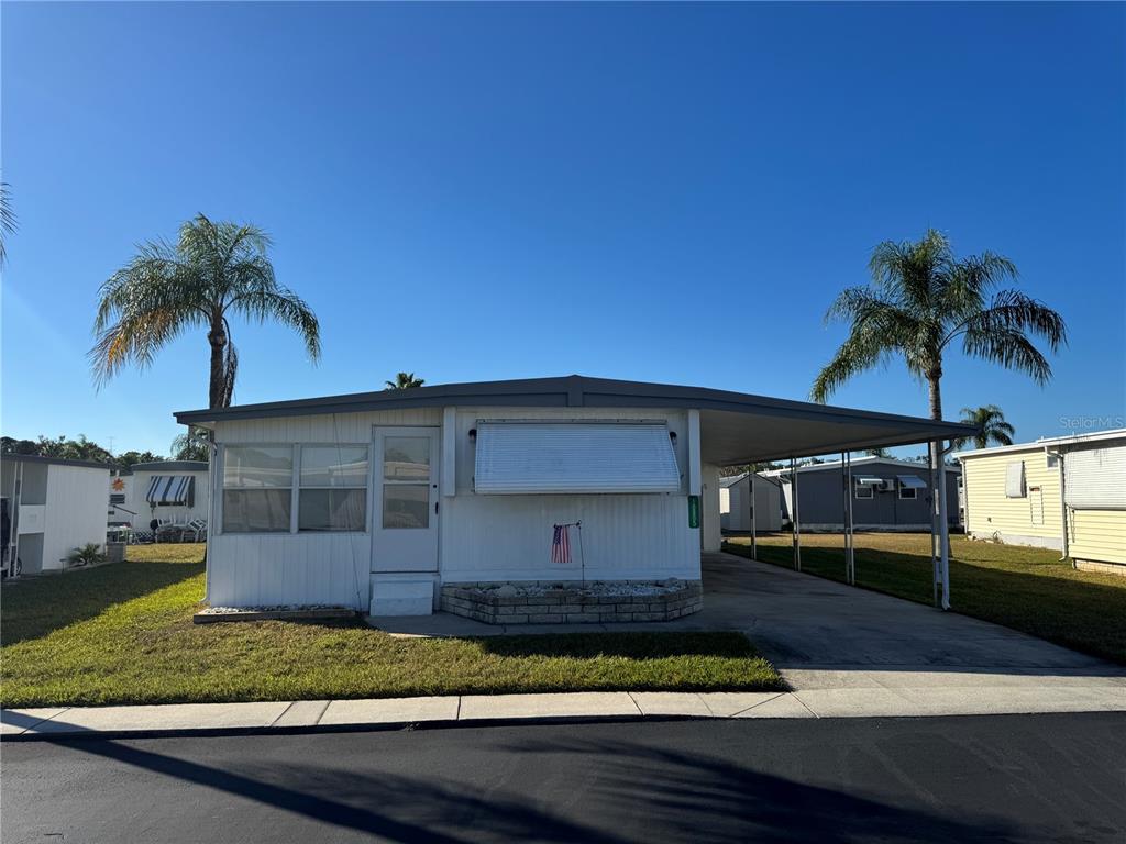 10805 Tioga Drive Port Richey, FL 34668 - Photo 15 of 15 a front view of a house with a yard and garage