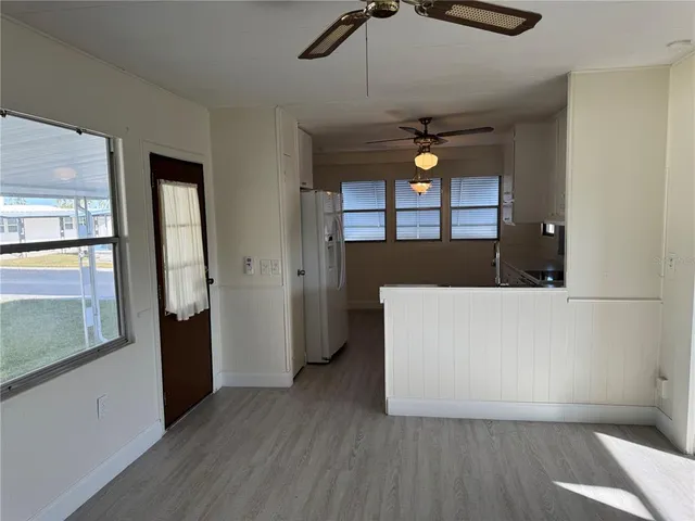 a living room with a bed furniture and a large window