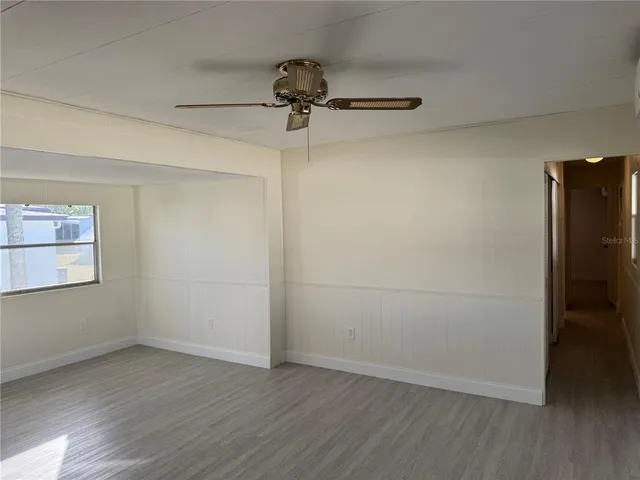 a view of a room with wooden floor