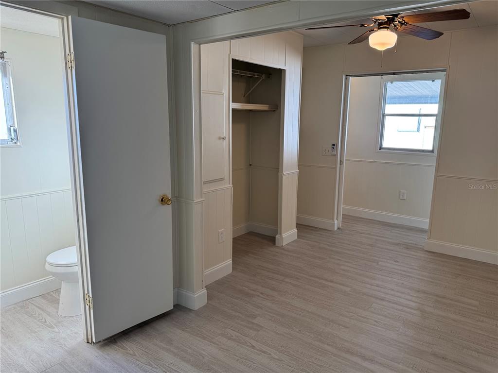 10805 Tioga Drive Port Richey, FL 34668 - Photo 10 of 15 a view of an empty room with wooden floor and a window