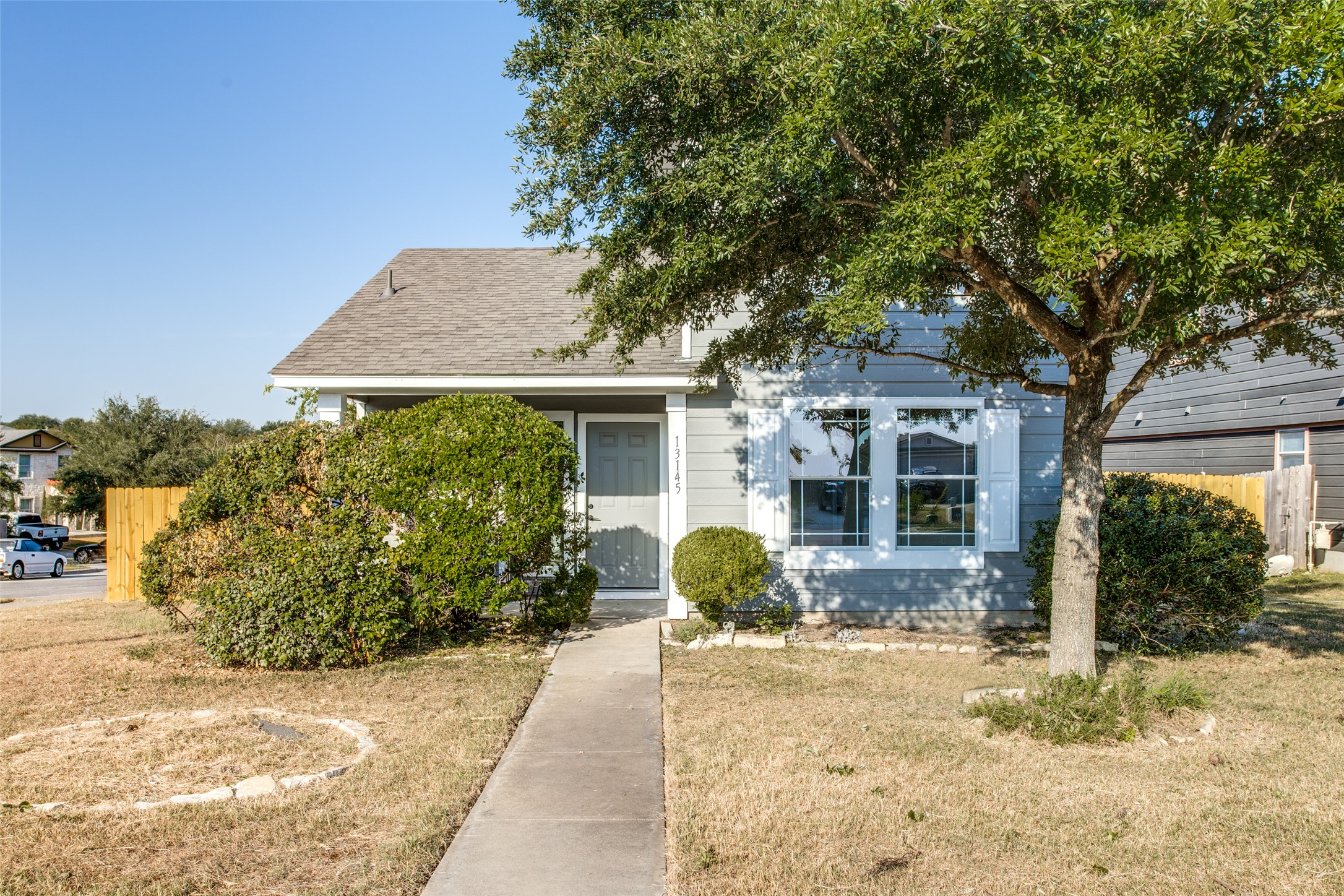 13145 Briarcreek Loop Manor, TX 78653 - Photo 2 of 25 a front view of a house with garden
