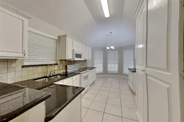 a kitchen with stainless steel appliances granite countertop a sink and cabinets