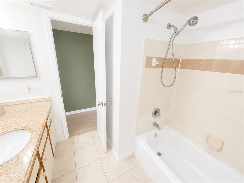 1908 Lake Atriums Circle, Unit 9 Orlando, FL 32839 - Photo 7 of 11 a bathroom with a bathtub a sink a toilet and a shower