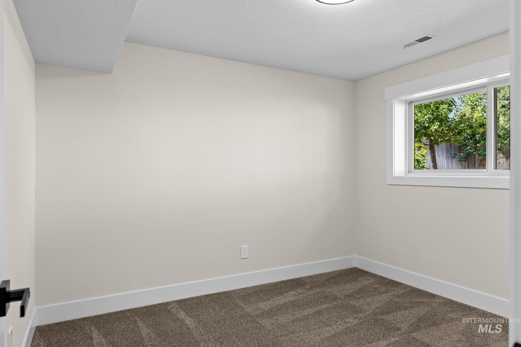 1675 Country Terrace Way Meridian, ID 83642 - Photo 28 of 50 Recessed window with white trim, tan wall paint, brown carpet, and white ceiling