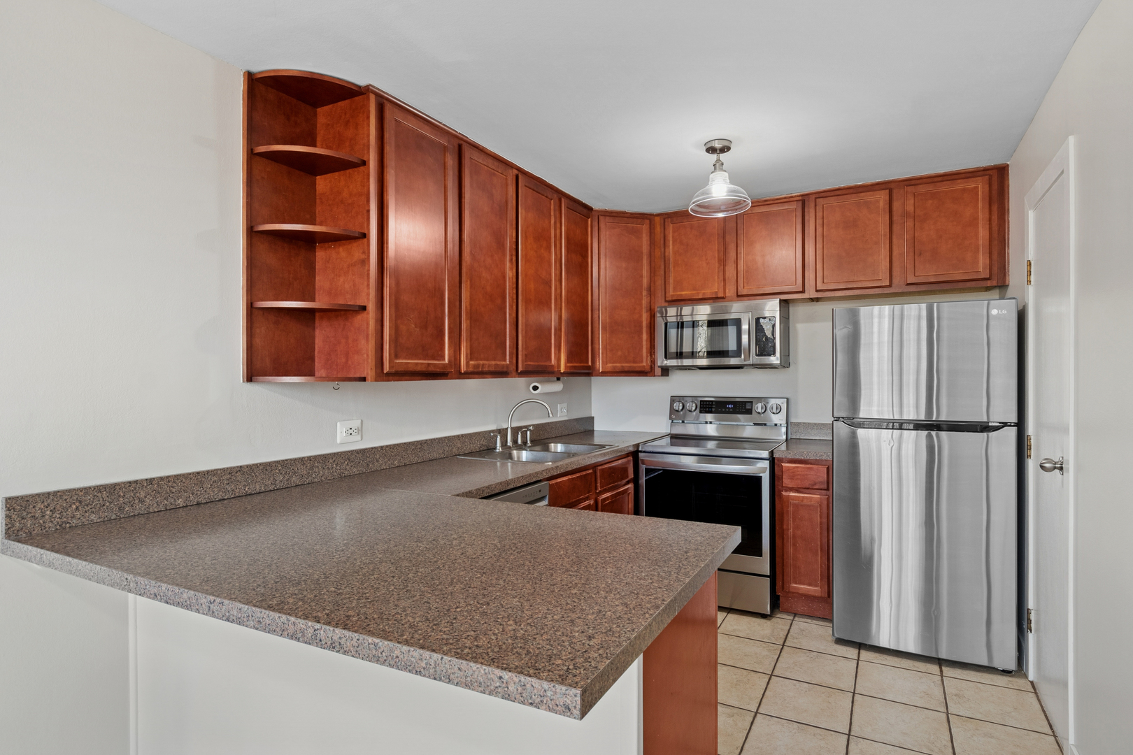 6012 Forest View Road, Unit 1D Lisle, IL 60532 - Photo 11 of 21 a kitchen with stainless steel appliances granite countertop a refrigerator a stove and a sink with wooden floor