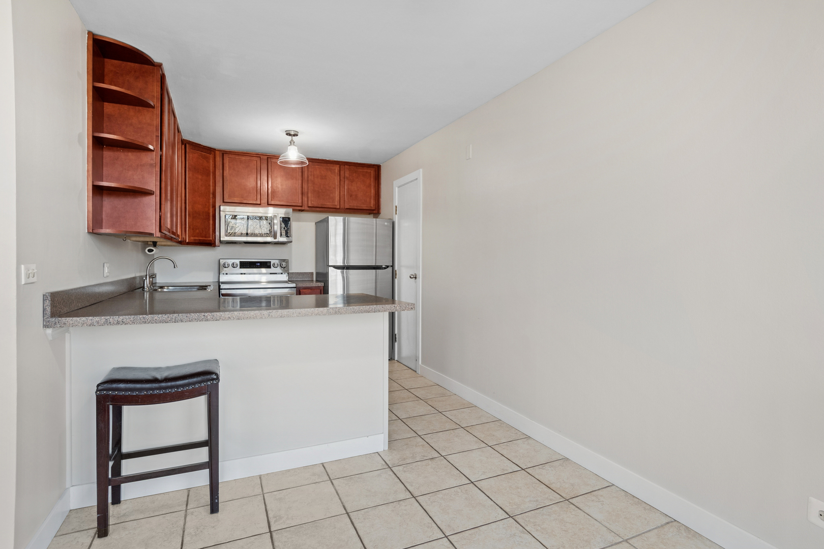 6012 Forest View Road, Unit 1D Lisle, IL 60532 - Photo 10 of 21 a kitchen with stainless steel appliances granite countertop a sink and a refrigerator
