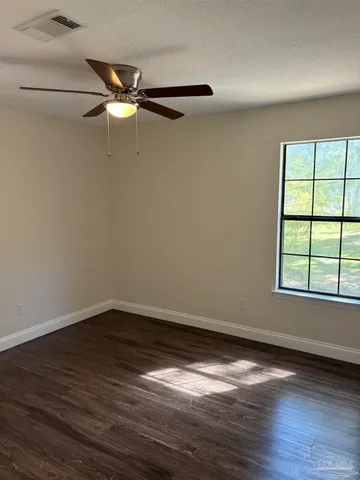 a view of a room with wooden floor cabinet and windows
