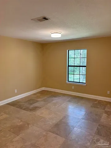 an empty room with windows and closet