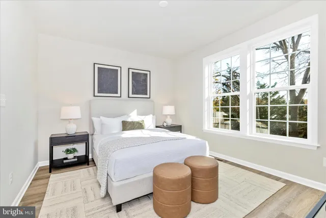 a bedroom with a bed and a large window