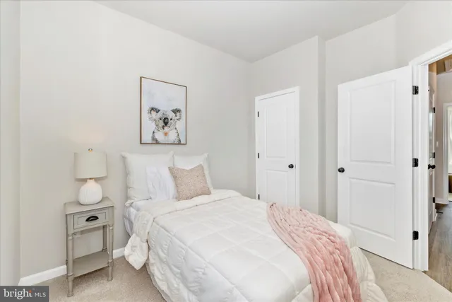 a bedroom with a bed and a painting on the wall