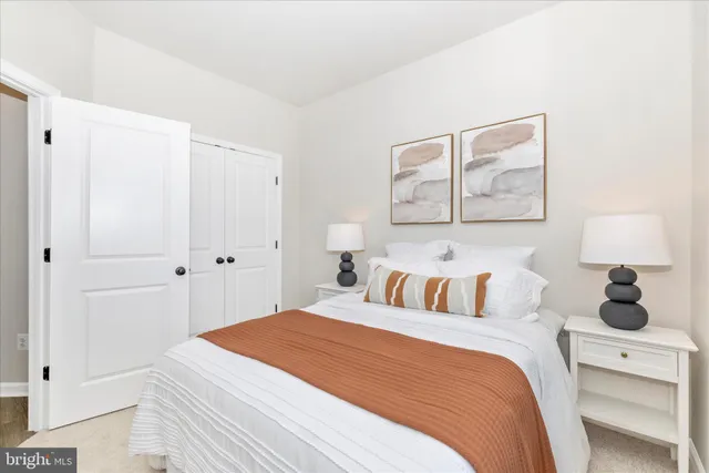 a bedroom with a bed and a lamp