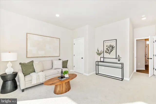 a living room with furniture and a painting