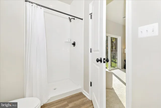 a bathroom with a shower and a toilet