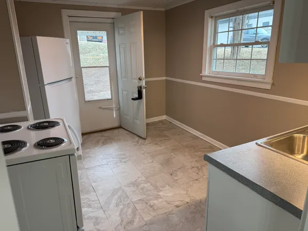 a view of a kitchen with a sink dishwasher and a window