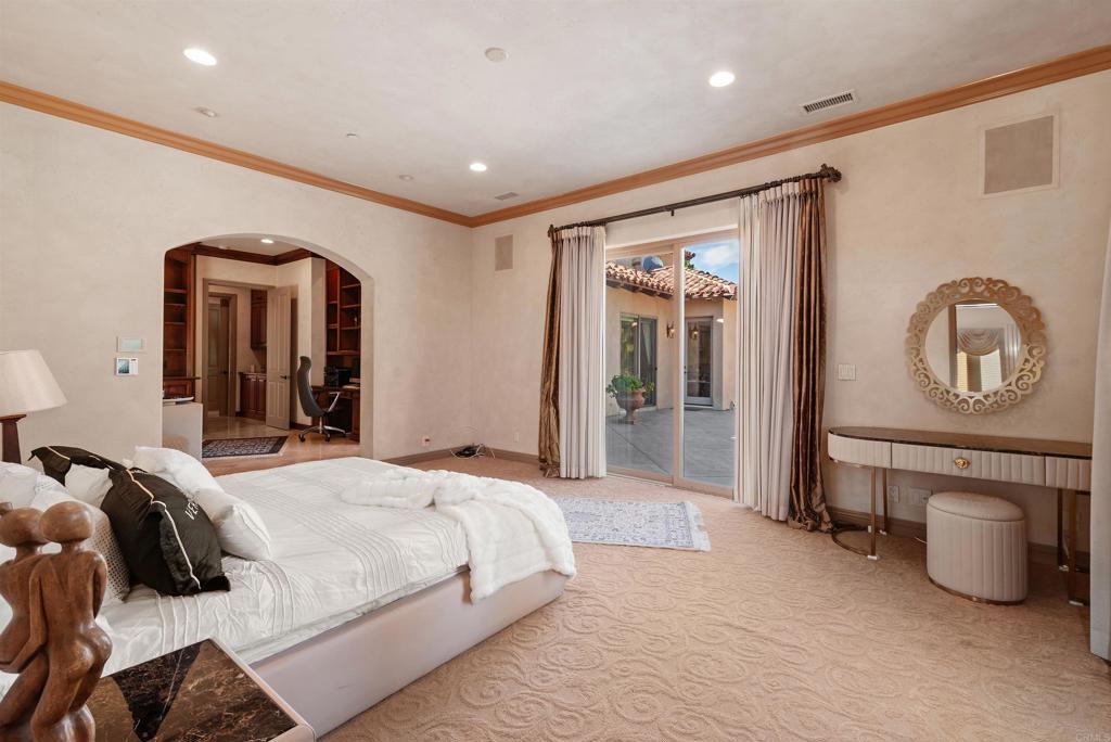 18545 Aliso Canyon Road Rancho Santa Fe, CA 92091 - Photo 26 of 48 a spacious bedroom with a bed a mirror and dresser