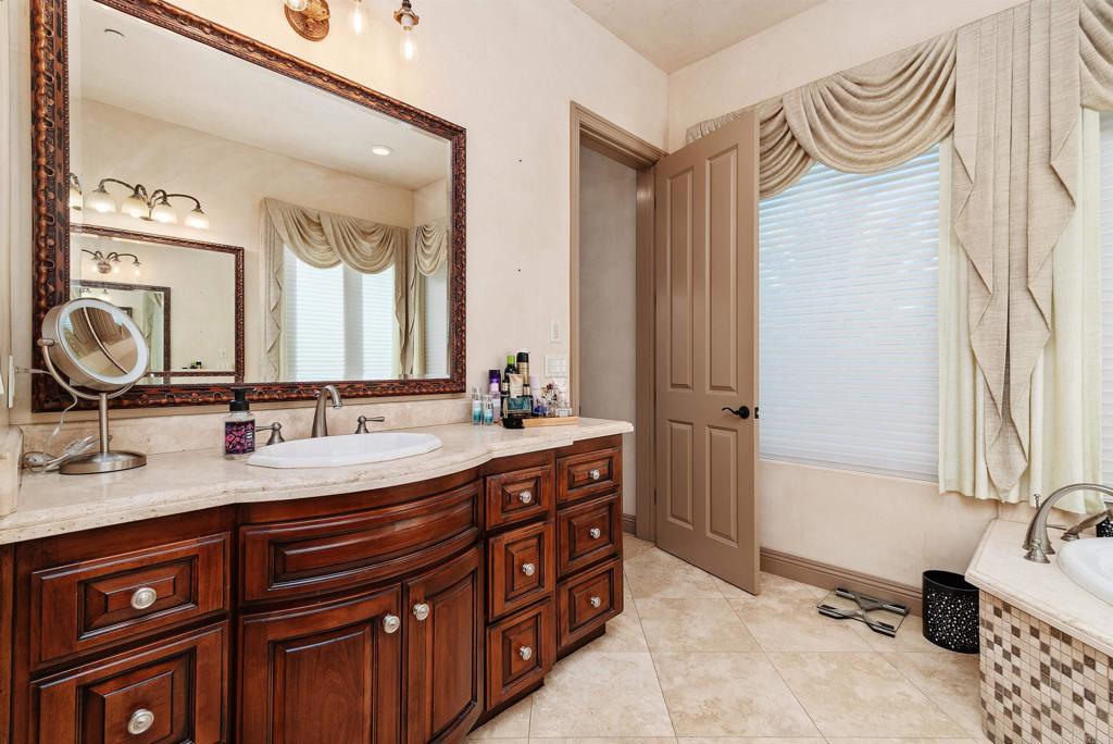 18545 Aliso Canyon Road Rancho Santa Fe, CA 92091 - Photo 28 of 48 a spacious bathroom with a double vanity sink double mirror and bathtub