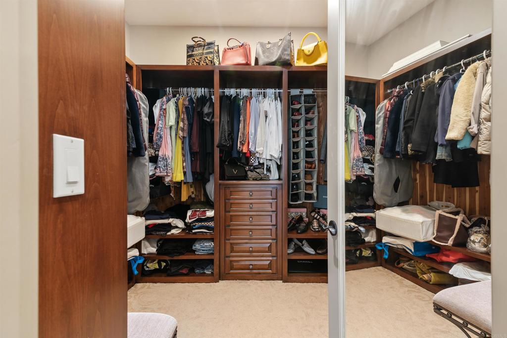 18545 Aliso Canyon Road Rancho Santa Fe, CA 92091 - Photo 29 of 48 a view of walk in closet with clothes and shoes