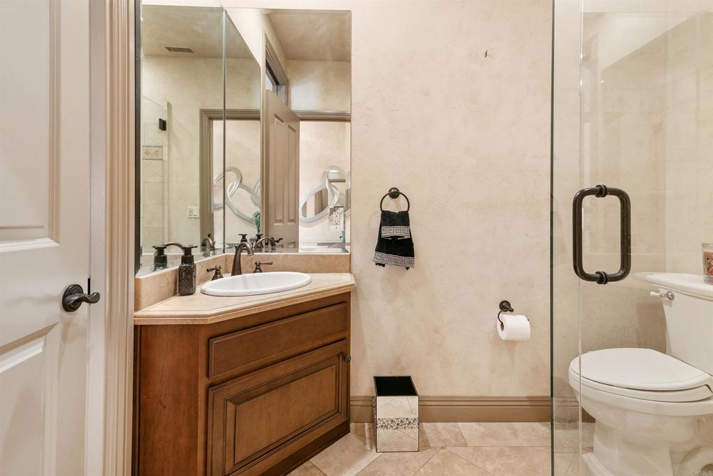 18545 Aliso Canyon Road Rancho Santa Fe, CA 92091 - Photo 32 of 48 a bathroom with a toilet sink and mirror