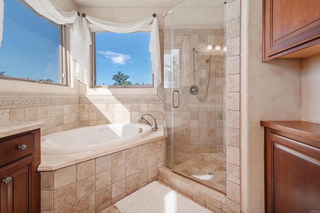 18545 Aliso Canyon Road Rancho Santa Fe, CA 92091 - Photo 38 of 48 a bathroom with a shower sink and mirror