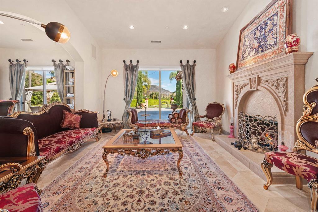 18545 Aliso Canyon Road Rancho Santa Fe, CA 92091 - Photo 6 of 48 a living room with furniture a rug and a large window