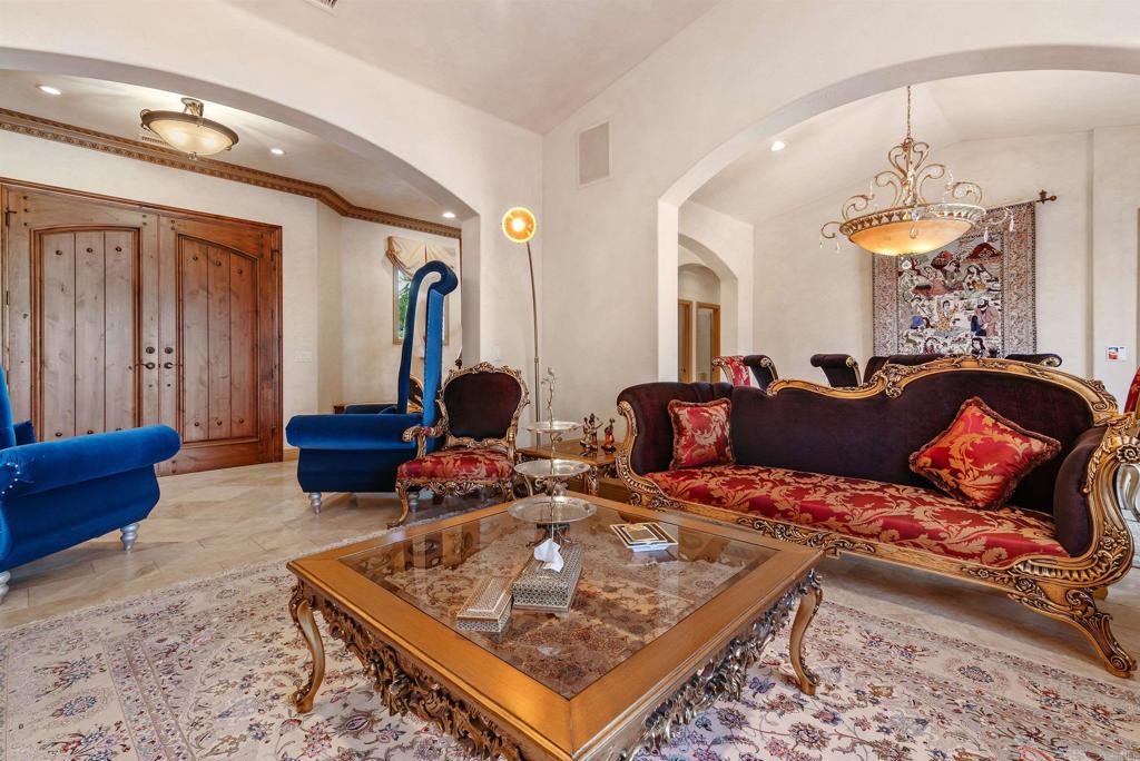 18545 Aliso Canyon Road Rancho Santa Fe, CA 92091 - Photo 8 of 48 a living room with furniture a chandelier and a rug
