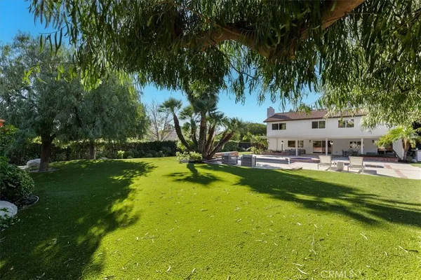a view of a backyard with large trees