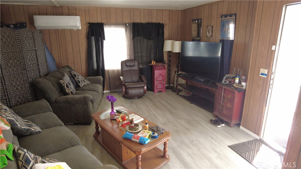 4561 Adobe Road, Unit 1 Twentynine Palms, CA 92277 - Photo 25 of 57 a living room with furniture and a flat screen tv
