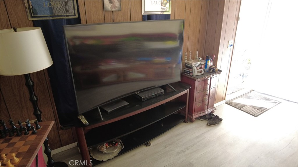 4561 Adobe Road, Unit 1 Twentynine Palms, CA 92277 - Photo 27 of 57 a living room with a bed furniture and a flat screen tv