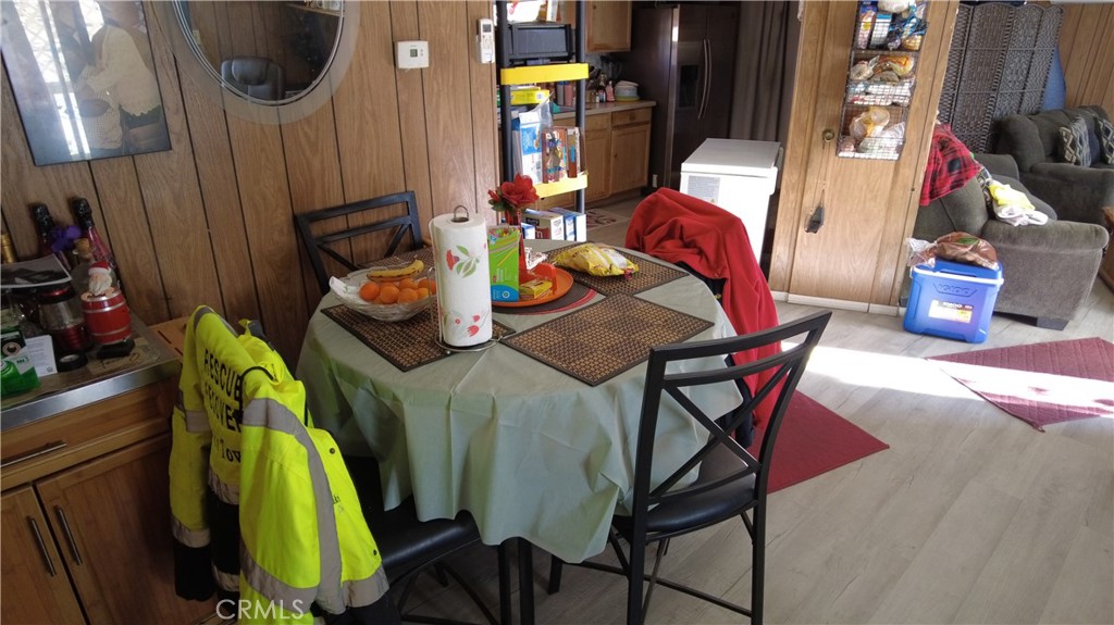 4561 Adobe Road, Unit 1 Twentynine Palms, CA 92277 - Photo 30 of 57 a dining room with furniture and wooden floor