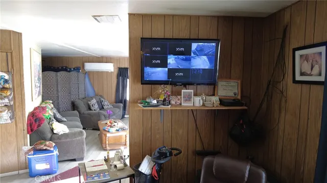 a view of living room with furniture and a floor to ceiling window