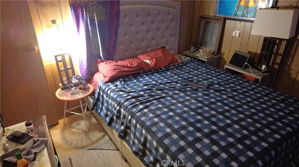 4561 Adobe Road, Unit 1 Twentynine Palms, CA 92277 - Photo 37 of 57 a bedroom with bed and a mirror