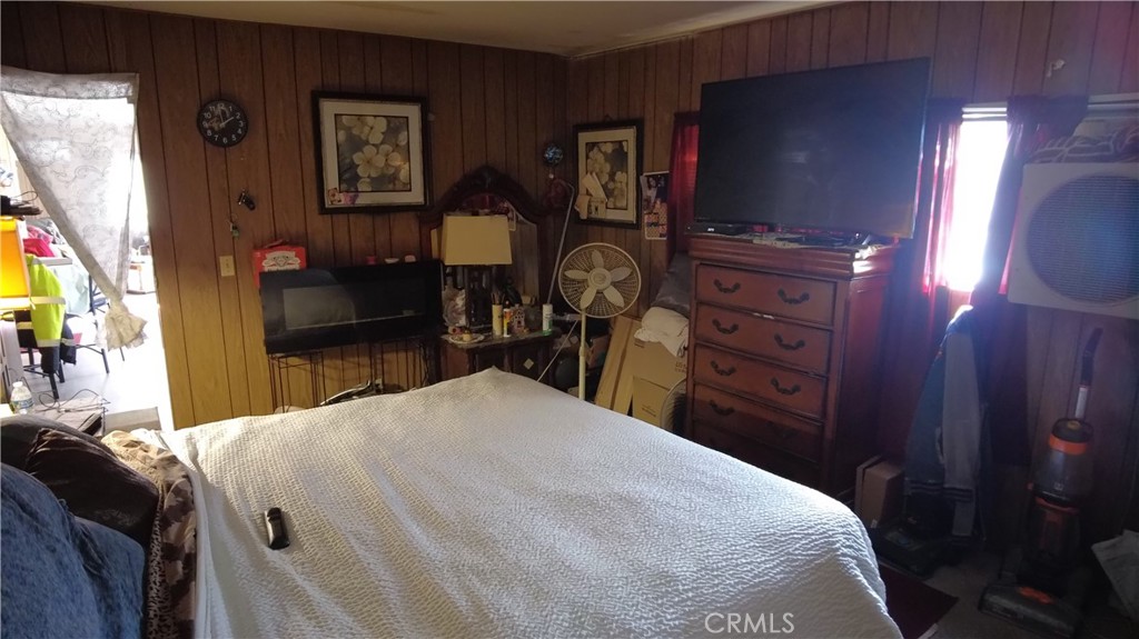 4561 Adobe Road, Unit 1 Twentynine Palms, CA 92277 - Photo 48 of 57 a bedroom with a bed and a mirror on dresser