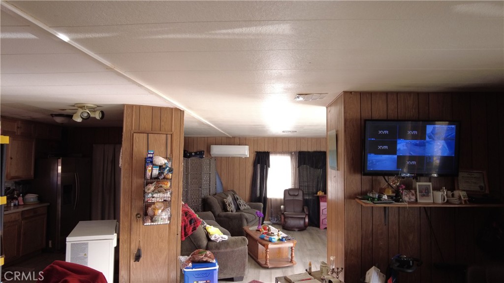 4561 Adobe Road, Unit 1 Twentynine Palms, CA 92277 - Photo 50 of 57 a living room with lots of furniture and a projector