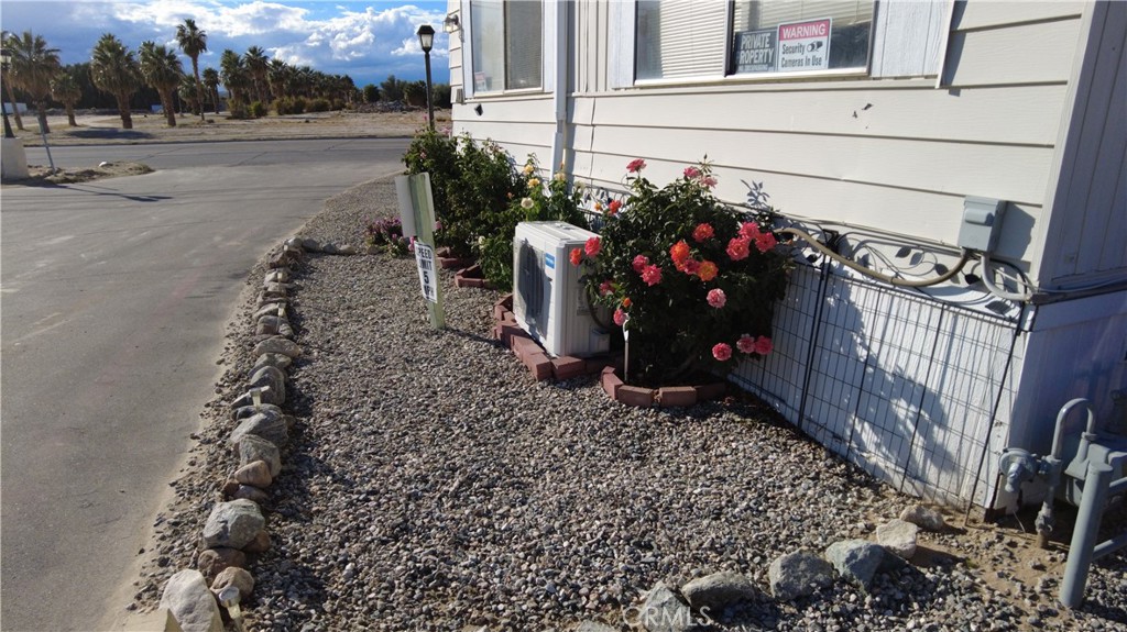4561 Adobe Road, Unit 1 Twentynine Palms, CA 92277 - Photo 5 of 57 a view of a house with a yard and potted plants