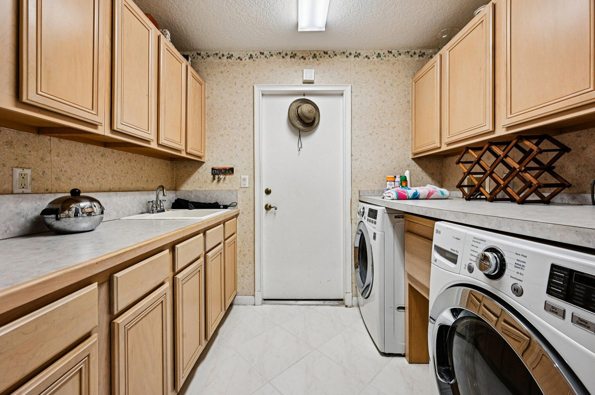 231 Sparrow Point Jupiter, FL 33458 - Photo 17 of 65 a utility room with dryer and washer