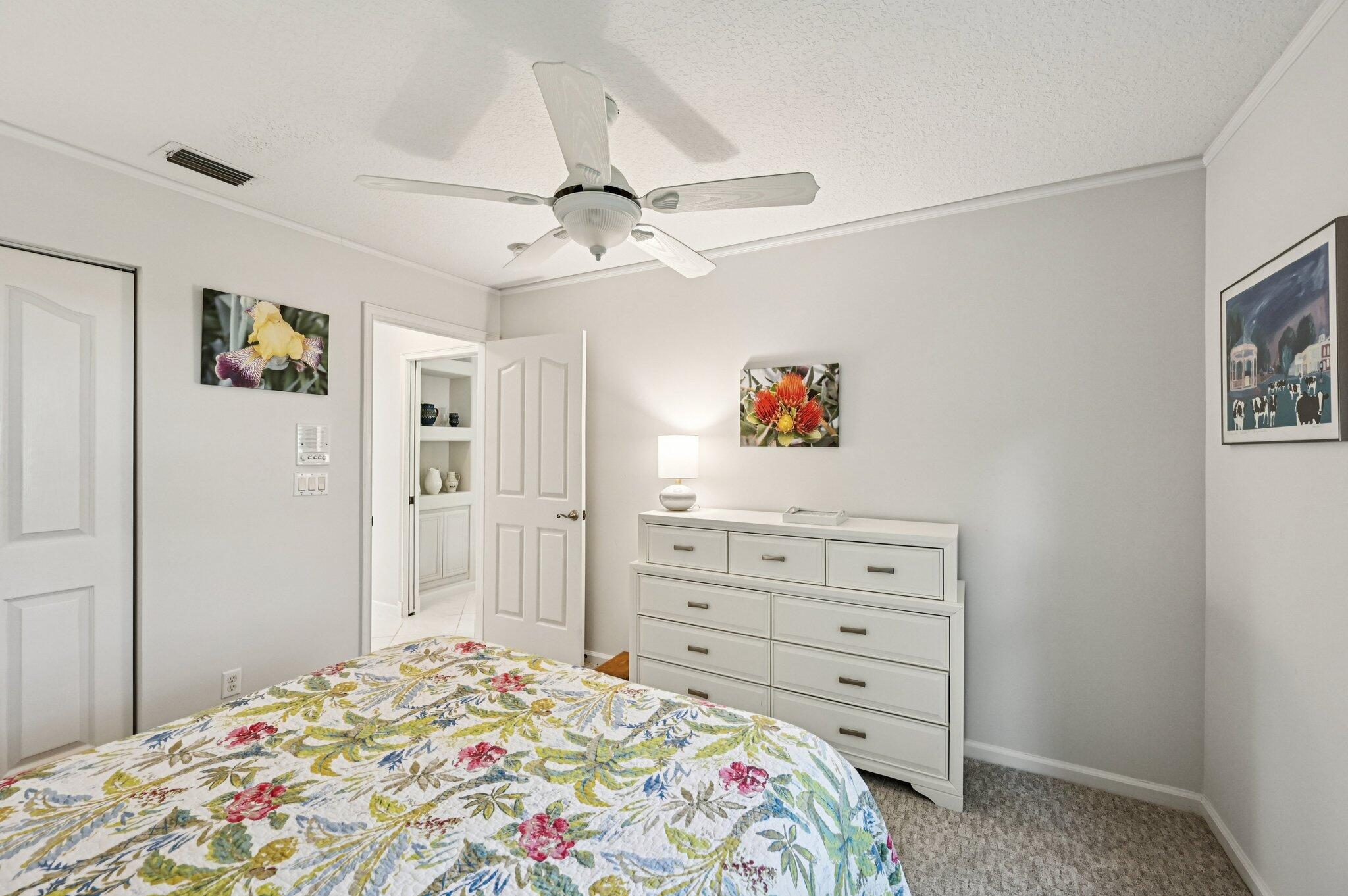 231 Sparrow Point Jupiter, FL 33458 - Photo 30 of 65 a bedroom with a bed and a dresser in it