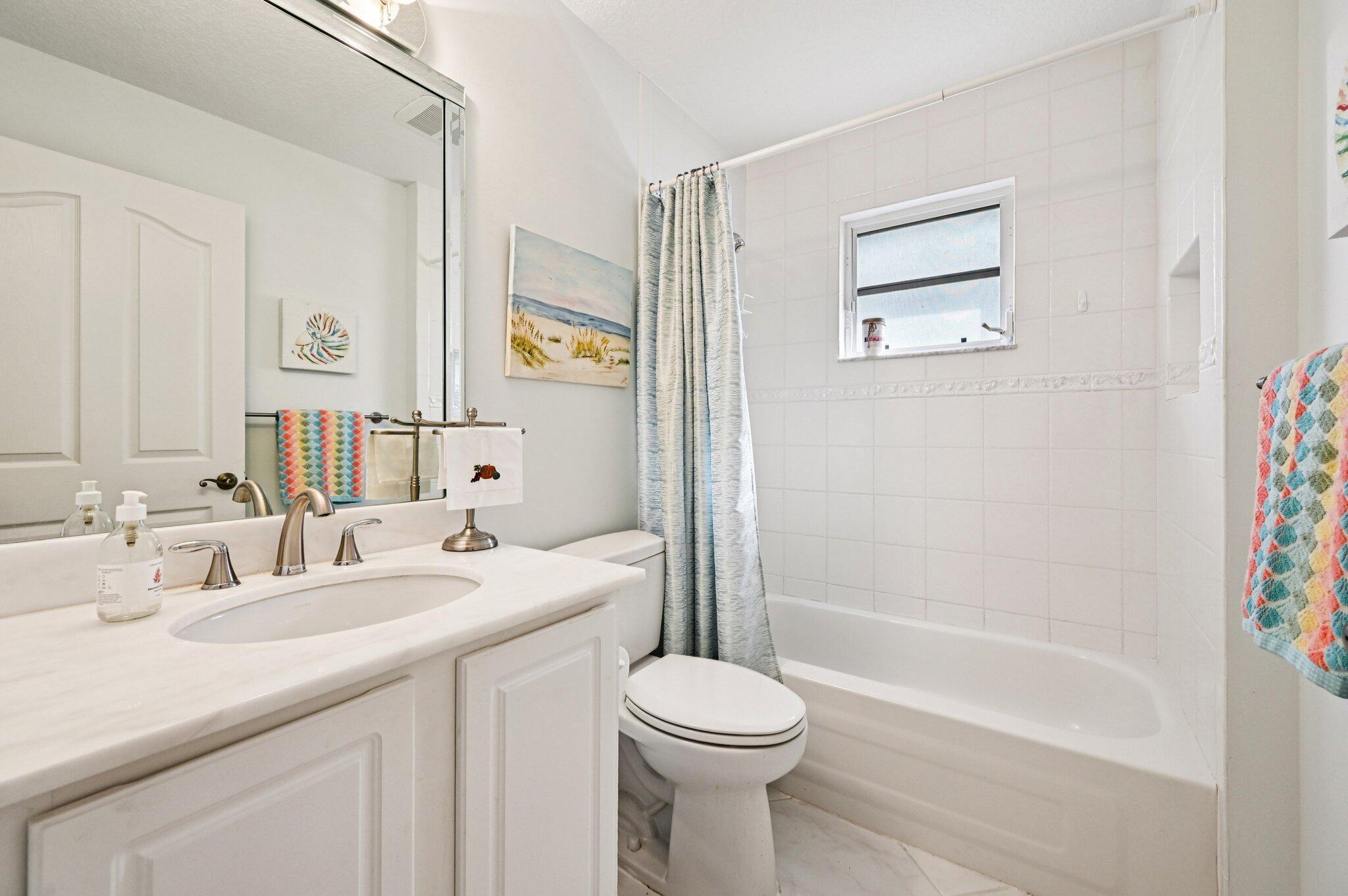 231 Sparrow Point Jupiter, FL 33458 - Photo 32 of 65 a bathroom with a sink a toilet and shower