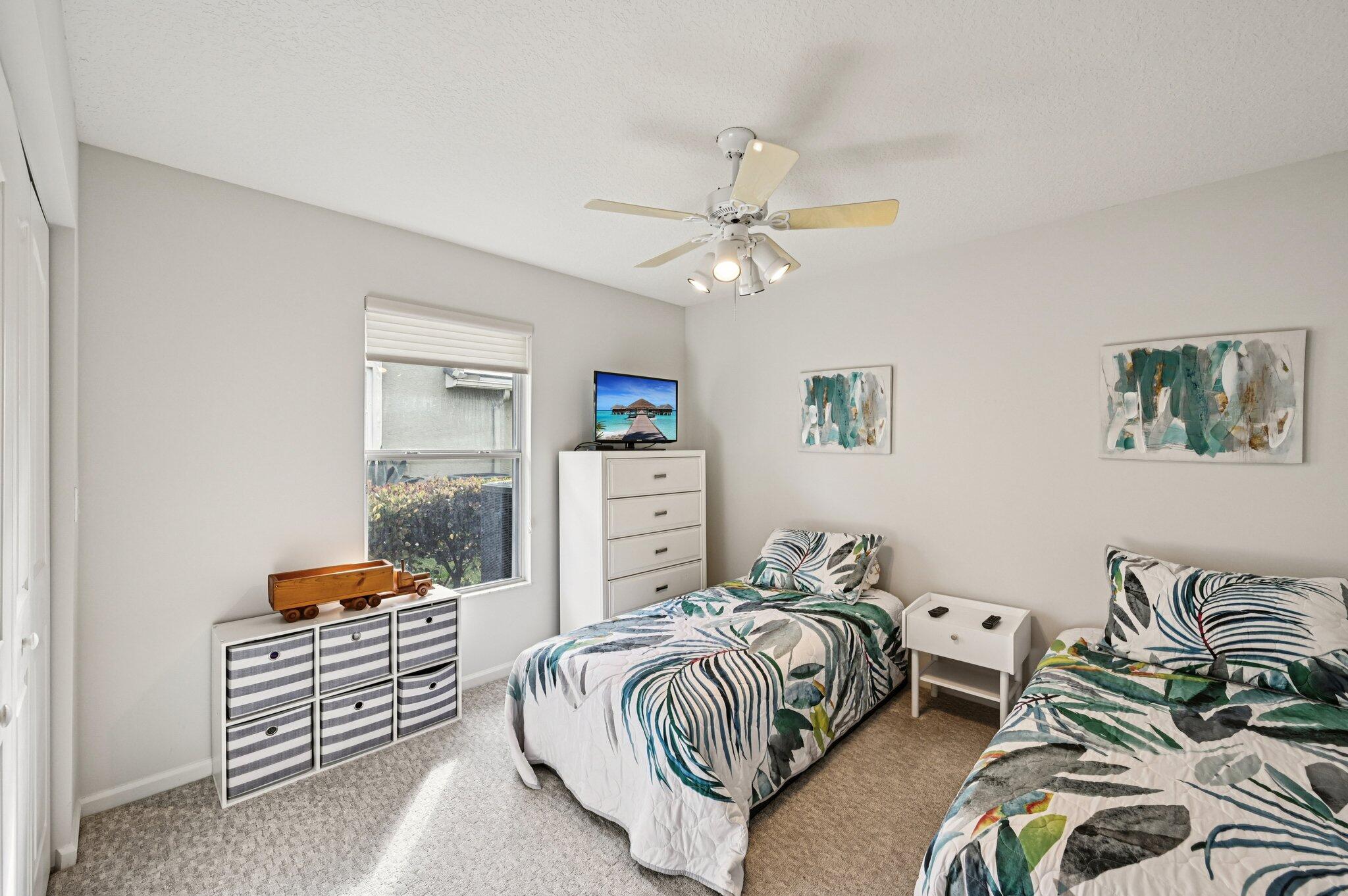 231 Sparrow Point Jupiter, FL 33458 - Photo 33 of 65 a bedroom with furniture and a chandelier