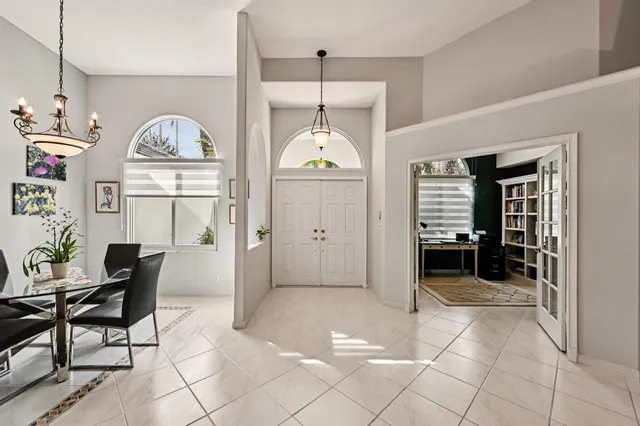 a living room with furniture a flat screen tv and a large window