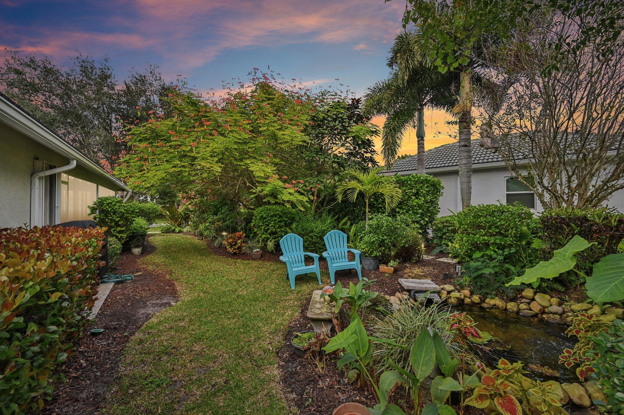 231 Sparrow Point Jupiter, FL 33458 - Photo 65 of 65 a backyard of a house with table and chairs