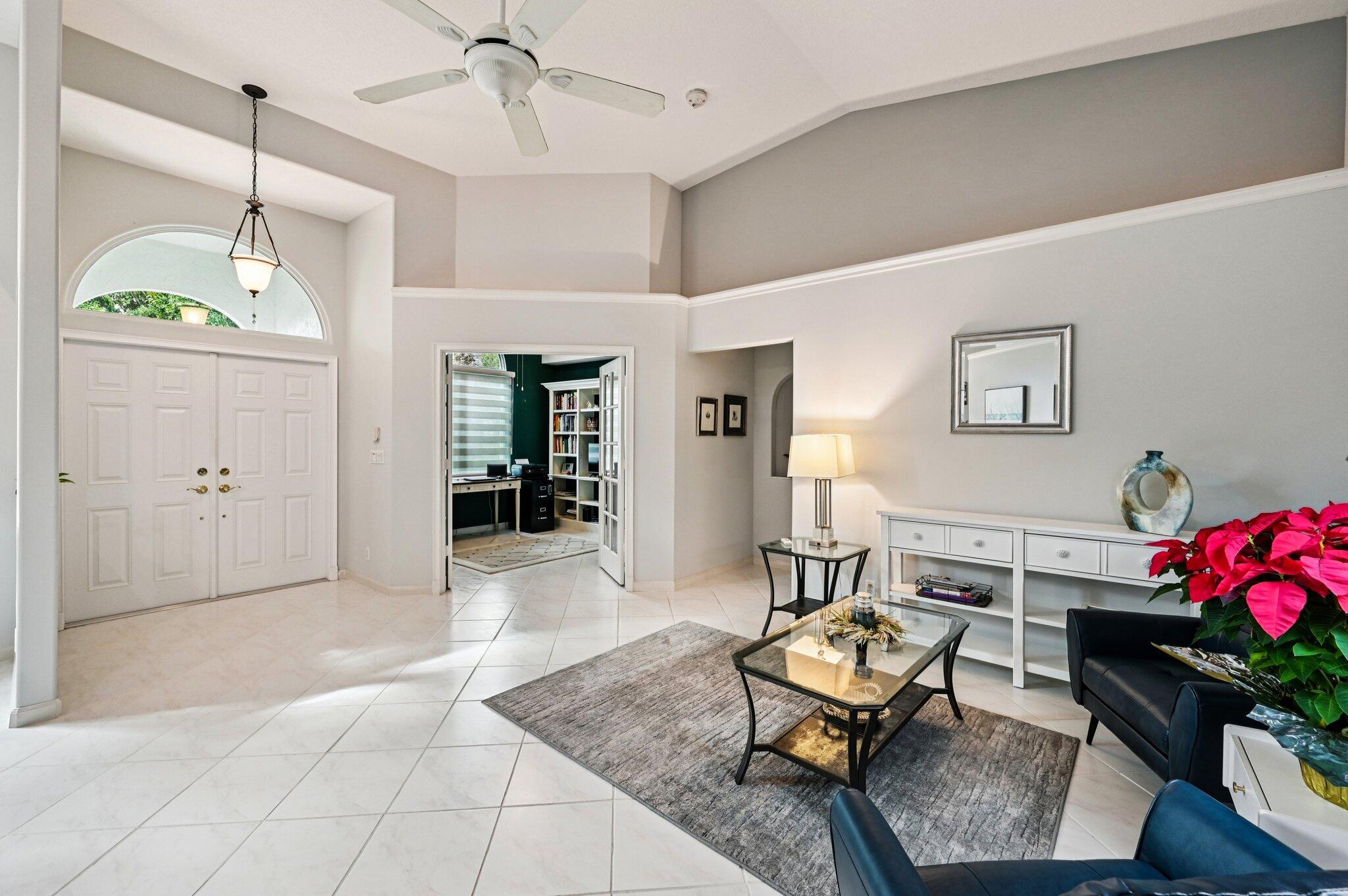 231 Sparrow Point Jupiter, FL 33458 - Photo 7 of 65 a living room with furniture and a chandelier