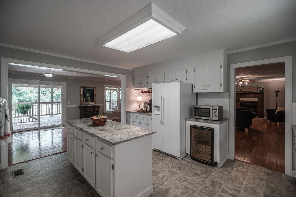 8114 Ridgewood Road Goodlettsville, TN 37072 - Photo 11 of 30 Updated kitchen with floating floors, new granite counter tops, island, pantry, built-in wine cooler and linoleum floors.